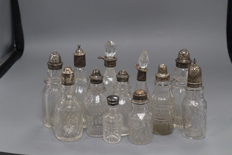 Six assorted 19th century silver topped glass cruets and six others with plated or white metal mounts, largest 18.5cm.